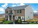 Two-story home with landscaping and a Sales Center for information at 5429 Flat Rock Point, Stonecrest, GA 30038