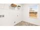 Functional laundry room with washer/dryer hookups, shelving, window and vinyl flooring at 5429 Flat Rock Point, Stonecrest, GA 30038