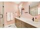 Elegant bathroom with double vanity, modern fixtures, and glass-enclosed shower at 944 Spencer Ave, Atlanta, GA 30318