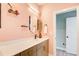 Modern bathroom with pink walls, decorative mirror, and stylish fixtures at 944 Spencer Ave, Atlanta, GA 30318