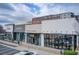 Commercial storefronts featuring businesses like Warby Parker and Herman Miller in a modern building at 944 Spencer Ave, Atlanta, GA 30318