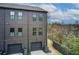 Two-story townhome showcasing dark gray siding, multiple windows, and attached garages at 944 Spencer Ave, Atlanta, GA 30318