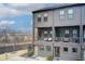 Modern three-story townhouse featuring private balconies and neutral gray brick and siding at 944 Spencer Ave, Atlanta, GA 30318