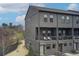 Contemporary three-story townhouse with private balconies and views of trees in the background at 944 Spencer Ave, Atlanta, GA 30318