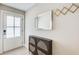 Bright foyer featuring a decorative front door, modern storage cabinet, and coat rack at 944 Spencer Ave, Atlanta, GA 30318