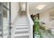 Foyer with staircase, views into the living room and kitchen, and plenty of light from the glass front door at 944 Spencer Ave, Atlanta, GA 30318