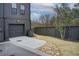 View of a single-car garage and driveway of a townhome with a fenced backyard at 944 Spencer Ave, Atlanta, GA 30318