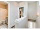 Hallway with two open doorways, one to a bathroom and one leading to a bedroom at 944 Spencer Ave, Atlanta, GA 30318
