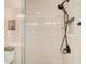 Shower with vertical tiling, black shower head, and inset shelf at 944 Spencer Ave, Atlanta, GA 30318