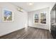 Sunlit bedroom with two windows, wood-look flooring and a mini-split air conditioner at 1106B Wedgewood Nw Dr, Atlanta, GA 30318