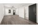 Well-lit bedroom featuring modern flooring, fresh paint, ceiling fan and adjacent half-bathroom at 1106B Wedgewood Nw Dr, Atlanta, GA 30318