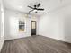 Light-filled bedroom with modern flooring, neutral paint, ceiling fan and exterior door access at 1106B Wedgewood Nw Dr, Atlanta, GA 30318