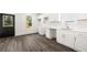 Modern white kitchen with sleek countertops, ample cabinet space and luxury vinyl plank flooring at 1106B Wedgewood Nw Dr, Atlanta, GA 30318