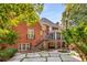 Beautiful backyard with stone patio, pool, and lush landscaping, perfect for outdoor entertaining at 1285 Wesley Nw Pl, Atlanta, GA 30327