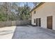 Large backyard with concrete patio, wooden fence, and lush greenery surrounding the house at 3597 Embry Cir, Atlanta, GA 30341