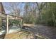 Exterior view of sunroom connected to a serene backyard setting with mature trees and a patio area at 3597 Embry Cir, Atlanta, GA 30341