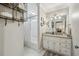 Well-lit bathroom with white vanity, granite countertop, shower and decorative shelving at 3597 Embry Cir, Atlanta, GA 30341