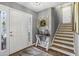 Inviting foyer featuring a white front door, staircase, decorative table, and neutral decor at 3597 Embry Cir, Atlanta, GA 30341