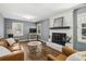 Inviting living room features a brick fireplace, wood floors, and plenty of natural light from several windows at 3597 Embry Cir, Atlanta, GA 30341