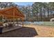 Outdoor covered seating area with a view of the tennis court in the backyard at 3597 Embry Cir, Atlanta, GA 30341