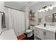 Bright bathroom featuring a white shower curtain, black tile flooring, and vanity with marble countertop at 655 Mead Se St # 7, Atlanta, GA 30312