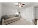 Neutral bedroom featuring a loveseat, ceiling fan, and two entry doors at 655 Mead Se St # 7, Atlanta, GA 30312
