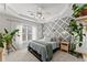 Main bedroom features ceiling fan, tray ceiling, neutral decor, patterned accent wall, and natural light at 655 Mead Se St # 7, Atlanta, GA 30312