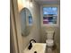 This updated bathroom features a new vanity, oval mirror, and wainscoting at 951 Bingham Ln, Stone Mountain, GA 30083