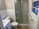 The bathroom features a tiled shower with glass doors, as well as an updated vanity at 951 Bingham Ln, Stone Mountain, GA 30083