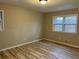 A bright bedroom offers wood-look floors and two windows for natural light and views at 951 Bingham Ln, Stone Mountain, GA 30083