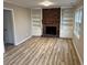 Cozy living room featuring a brick fireplace, built-in shelving, and luxury vinyl plank flooring at 951 Bingham Ln, Stone Mountain, GA 30083