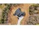 Aerial view of a home on a large lot surrounded by trees, featuring a dark shingle roof at 1629 Phillips Rd, Lithonia, GA 30058