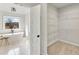 Bathroom with modern tub and a view to the outside, leads to a shelved walk-in closet at 1629 Phillips Rd, Lithonia, GA 30058
