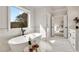 Bright bathroom featuring a modern soaking tub with a faucet and a view at 1629 Phillips Rd, Lithonia, GA 30058