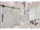 Modern bathroom featuring marble tile, a glass shower, and a white vanity at 1629 Phillips Rd, Lithonia, GA 30058