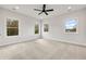 Spacious bedroom with large windows, bright interior, and neutral carpeting at 1629 Phillips Rd, Lithonia, GA 30058