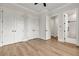 Bright bedroom featuring multiple closets, light wood floors, and an entrance to the bathroom at 1629 Phillips Rd, Lithonia, GA 30058