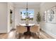 Cozy dining room features a modern chandelier and views of the outdoors at 1629 Phillips Rd, Lithonia, GA 30058