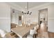 Open dining area featuring a wooden table, matching chairs, and modern light fixture at 1629 Phillips Rd, Lithonia, GA 30058