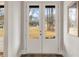 View from inside home looking at white double doors and a framed picture on the wall at 1629 Phillips Rd, Lithonia, GA 30058
