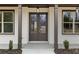 Close-up of the front entrance with double doors, large windows, and decorative columns at 1629 Phillips Rd, Lithonia, GA 30058