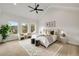 Bright main bedroom featuring high ceilings, neutral décor, and three windows at 1629 Phillips Rd, Lithonia, GA 30058
