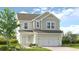 Charming two-story home with vertical siding, a two-car garage, and a well-manicured lawn at 211 Groveton Ct, Euharlee, GA 30145