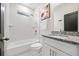 Well-lit bathroom featuring a shower over tub, granite vanity, and white subway tile at 2668 Brown Nw St, Atlanta, GA 30318
