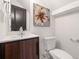Modern bathroom with a sleek sink, wood vanity, and stylish flower art at 2668 Brown Nw St, Atlanta, GA 30318