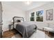 Comfortable bedroom with wood floors, plush bedding, large windows, and stylish decor at 2668 Brown Nw St, Atlanta, GA 30318