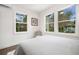 Bright bedroom featuring large windows with views of nature and a comfortable bed at 2668 Brown Nw St, Atlanta, GA 30318
