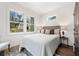 Cozy bedroom featuring a comfortable bed, wood floors, and sunlit windows providing natural light at 2668 Brown Nw St, Atlanta, GA 30318