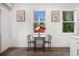 Cozy dining area with a small table, two chairs, and natural light streaming through the windows at 2668 Brown Nw St, Atlanta, GA 30318