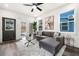 Bright living room with gray sectional sofa, glass coffee table, ceiling fan, and stylish decor at 2668 Brown Nw St, Atlanta, GA 30318